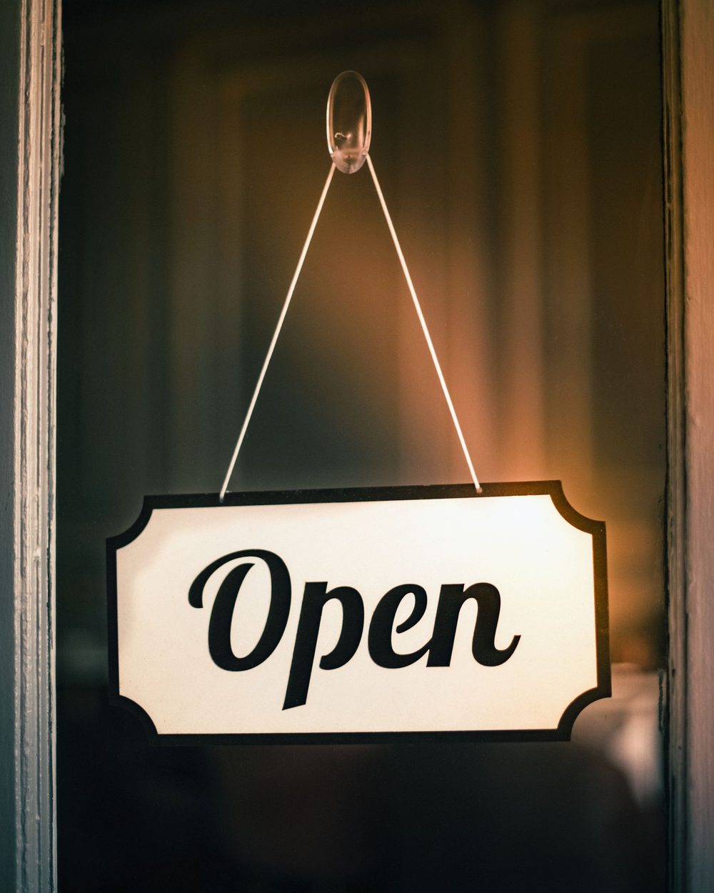 An Open sign hanging on a shop door