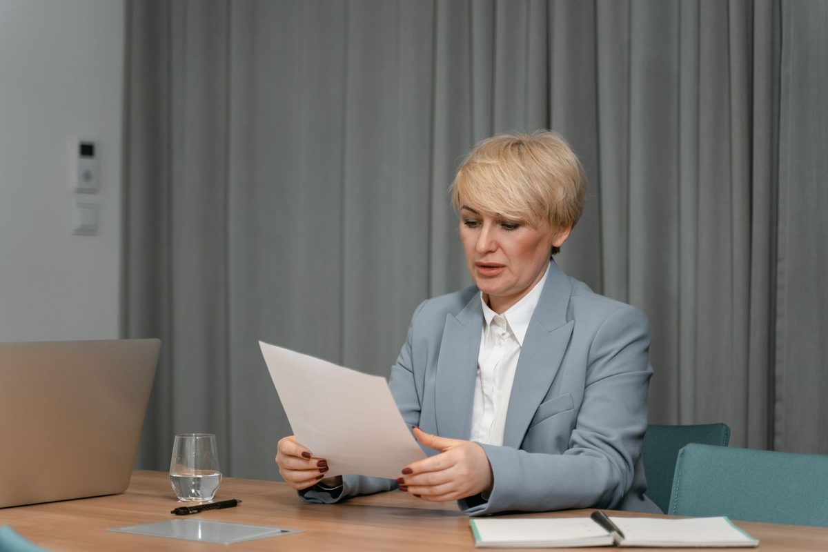 A business owner reviewing a document at a desk